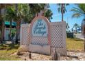 The Beach Cottage II sign with palm trees against a blue sky at 18400 Gulf Blvd # 2505, Indian Shores, FL 33785