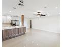 Spacious open-concept space with modern lighting, tile floors, and stylish ceiling fan at 2016 Cove Dr, Largo, FL 33774