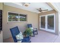 Relaxing covered patio featuring comfortable rocking chairs and a ceiling fan for outdoor enjoyment at 2120 S Hesperides St, Tampa, FL 33629