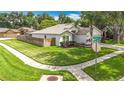 Corner lot showcasing the house's side exterior, a well-kept lawn, and partial fencing at 2601 Brookville Dr, Valrico, FL 33596