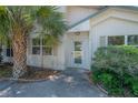 Charming entryway with a glass door, side windows, and tropical landscaping at 3256 Adrian Ave, Largo, FL 33774
