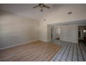 Bright living room features tile and laminate flooring, a ceiling fan, and high ceilings at 3256 Adrian Ave, Largo, FL 33774
