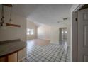 Open-concept living space includes a view of the kitchen and access to other rooms at 3256 Adrian Ave, Largo, FL 33774
