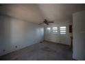 View of the living room showcasing natural light from multiple windows and worn carpet at 3258 Adrian Ave, Largo, FL 33774
