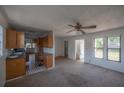 View of the open floorplan featuring the living room, kitchen, and front entry at 3258 Adrian Ave, Largo, FL 33774