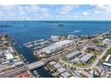 Scenic aerial view of the marina and waterfront community with ocean views and clear blue skies at 340 Causeway Blvd # 104, Dunedin, FL 34698