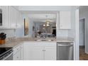 Efficient kitchen featuring granite countertops, stainless appliances, and convenient pass-through at 340 Causeway Blvd # 104, Dunedin, FL 34698