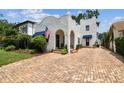 Charming two-story home with unique stucco exterior and brick driveway at 3405 W Palmira Ave, Tampa, FL 33629
