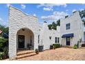 Charming two-story home with unique stucco exterior and brick driveway at 3405 W Palmira Ave, Tampa, FL 33629