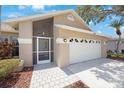 A close up of the exterior with a two car garage and screened front porch at 3834 102Nd N Pl, Clearwater, FL 33762