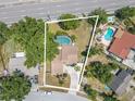 Aerial view of property featuring a large pool, patio, and fenced yard at 3968 Orchard Hill Cir, Palm Harbor, FL 34684