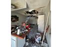 Fire damaged kitchen area, with debris scattered on the counter and floor at 4010 Cedarlimb Ct, Tampa, FL 33614