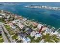 Aerial view of waterfront neighborhood featuring beautiful homes, lush landscaping, and boat docks at 405 8Th N Ave, Tierra Verde, FL 33715
