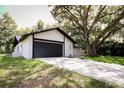 View of the side of the home, showcasing the garage, and driveway at 4260 Saint Lawrence Dr, New Port Richey, FL 34655