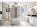 Luxurious bathroom featuring a soaking tub, tiled walls, and modern vanity at 4353 Dewey Dr, New Port Richey, FL 34652