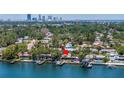 Aerial view showcasing the property's waterfront location with a private dock and city skyline views at 4649 Neptune Se Dr, St Petersburg, FL 33705