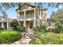 Attractive two-story home with a welcoming front porch and well-maintained landscaping at 5401 Match Point Pl, Lithia, FL 33547