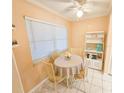 Bright breakfast nook featuring a round table, four chairs, and natural light from a window at 6060 Shore S Dr # 906, Gulfport, FL 33707