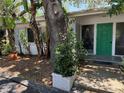 Inviting front entrance with a vibrant green door, lush greenery, and a well-maintained exterior at 7601 Pine Hill Dr, Tampa, FL 33617