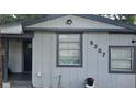 View of exterior with light gray siding, dark trim, and house number 9307 at 9307 N 16Th St, Tampa, FL 33612