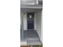 A close-up shot of the front door, steps, and gray railings of the porch at 9307 N 16Th St, Tampa, FL 33612