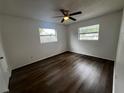 Cozy bedroom with hardwood floors and natural light from two windows at 103 Inwood Cir, Brandon, FL 33510