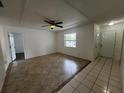 Bright living room featuring tile flooring, a ceiling fan, and neutral paint tones at 103 Inwood Cir, Brandon, FL 33510