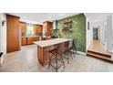 Modern kitchen featuring a subway tile backsplash, stainless steel appliances, and an island with bar seating at 1120 43Rd N Ave, St Petersburg, FL 33703