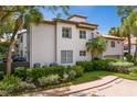 Rear exterior view of a two-story home with manicured landscaping and a brick paved driveway at 1122 Shipwatch Cir, Tampa, FL 33602