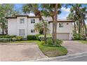 Beautiful two-story house with lush landscaping, a red tile roof, and a brick paver driveway at 1122 Shipwatch Cir, Tampa, FL 33602