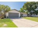Lovely single-story home with a well-manicured lawn, large driveway and a two-car garage on a sunny day at 11296 115Th St, Largo, FL 33778