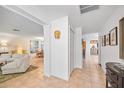 Inviting foyer boasts neutral tile flooring, artful decor, and seamless flow into the living and dining areas at 1235 Nelson St, Dunedin, FL 34698
