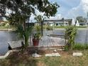 Property with a dock and boat lift in a serene canal setting at 13314 Lisa Dr, Hudson, FL 34667