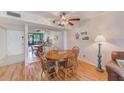 Dining area showing wood table and chairs, views to the living room, and a ceiling fan at 14130 Rosemary Ln # 4115, Largo, FL 33774
