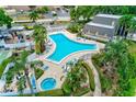 Enjoy the community pool with lush landscaping, a hot tub, and plenty of seating for residents at 14130 Rosemary Ln # 4115, Largo, FL 33774
