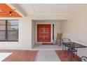 Welcoming front porch featuring a double door entry, red brick pathway and outdoor seating at 14168 Fennsbury Dr, Tampa, FL 33624