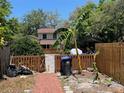 Private backyard with a wooden fence and brick pathway, ideal for outdoor enjoyment and entertaining at 14667 Pine Glen Crk # 14667, Lutz, FL 33559