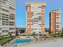 Beautiful outdoor pool area with palm trees, lounge chairs, and ocean views at 17900 Gulf Blvd # 16C, Redington Shores, FL 33708