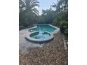 Sparkling pool and jacuzzi combination, ideal for relaxation and recreation at 1831 Pasadena Dr, Dunedin, FL 34698