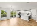 Bright, modern kitchen features stainless appliances, island, and hardwood floors at 2032 Sunset Meadow Dr, Clearwater, FL 33763