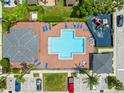Aerial view of community pool, featuring lounge chairs, playground, and ample parking at 2032 Sunset Meadow Dr, Clearwater, FL 33763