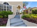 Charming front entrance with decorative wreaths, plants, and a pillar supporting an arched entryway at 230 Columbia Dr, Tampa, FL 33606