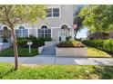 Inviting front entrance with steps leading to a charming home, enhanced by colorful landscaping at 230 Columbia Dr, Tampa, FL 33606