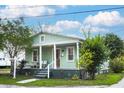 Classic single-Gathering home showcasing a cozy covered front porch at 2320 E 12Th Ave, Tampa, FL 33605