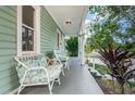 Inviting covered front porch with ample seating to enjoy the outdoors at 2320 E 12Th Ave, Tampa, FL 33605