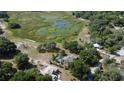 Overhead image showcasing the property with scenic views of the tranquil surrounding landscape and nearby bodies of water at 34389 Orchid Pkwy, Ridge Manor, FL 33523