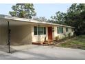 Inviting single-story home with a quaint red door and convenient carport at 406 2Nd Sw St, Ruskin, FL 33570