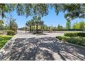 Gated community entrance featuring lush greenery, brick columns, and an iron fence at 5024 Sylvester Loop, Tampa, FL 33610
