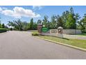 REGO PALMS neighborhood entrance with brick columns, an iron fence, and lush greenery at 5024 Sylvester Loop, Tampa, FL 33610