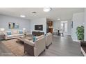 Spacious living room with hardwood floors, stylish furniture, and a cozy atmosphere perfect for entertaining at 5027 Overton Dr, New Port Richey, FL 34652